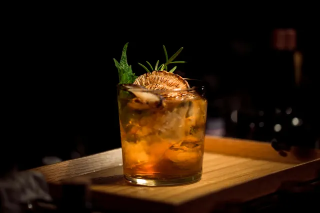 A dark lounge bar beside a gaming space